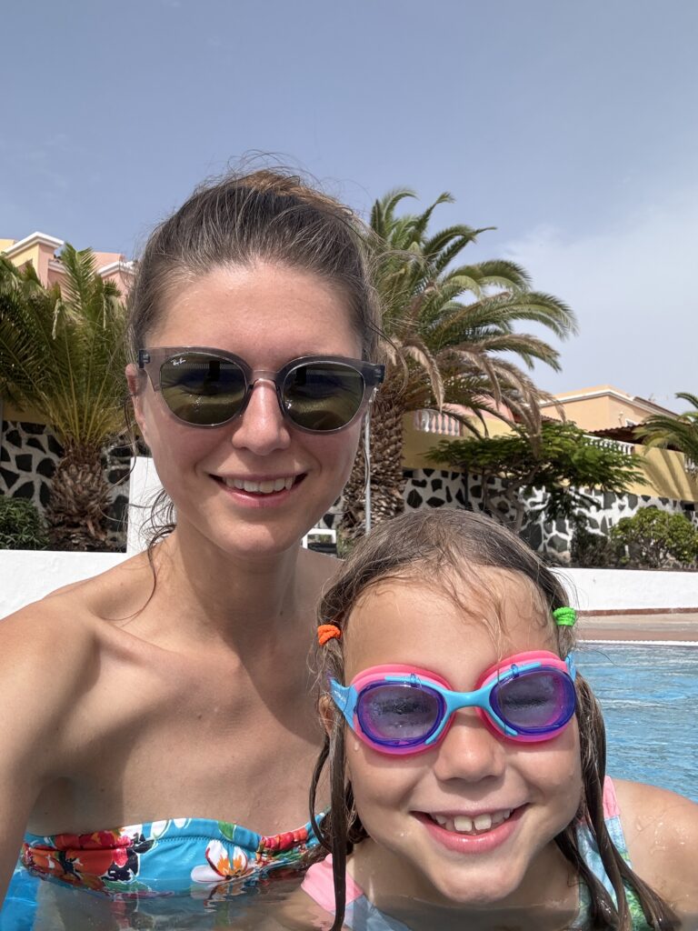 Mama su dukra viešajame baseine, leidžiančios laiką vandenyje ir plaukiojančios kartu